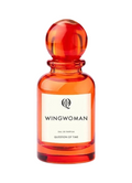 CR Signature QOT Wingwoman Eau de Parfum in a vibrant orange glass bottle with a round cap against a dark background.