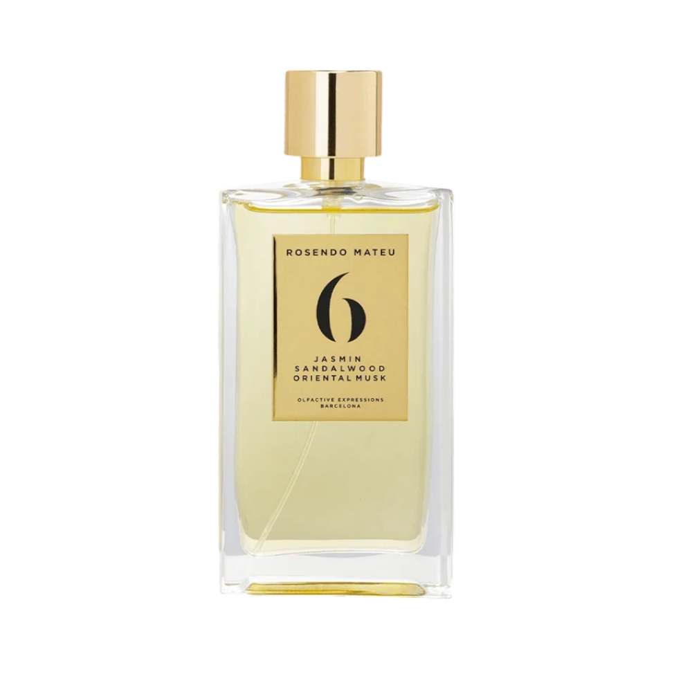CR Signature Rosendo Mateu Nº 6 perfume bottle with gold label against a dramatic black background with powder effect