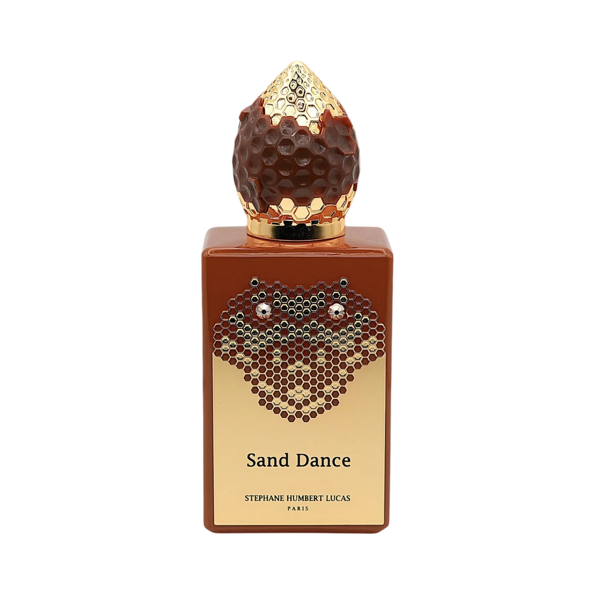 CR Signature Stéphane Humbert Lucas Sand Dance perfume bottle with gold honeycomb cap against a black powder background