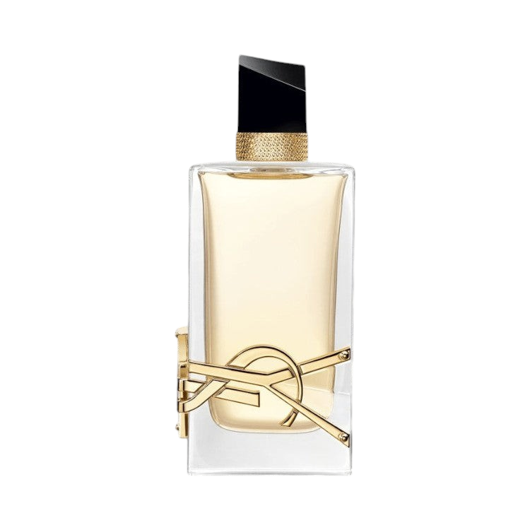 CR Signature Yves Saint Laurent Libre Eau de Parfum med gullfarget YSL-logo mot en dramatisk sort bakgrunn med støv